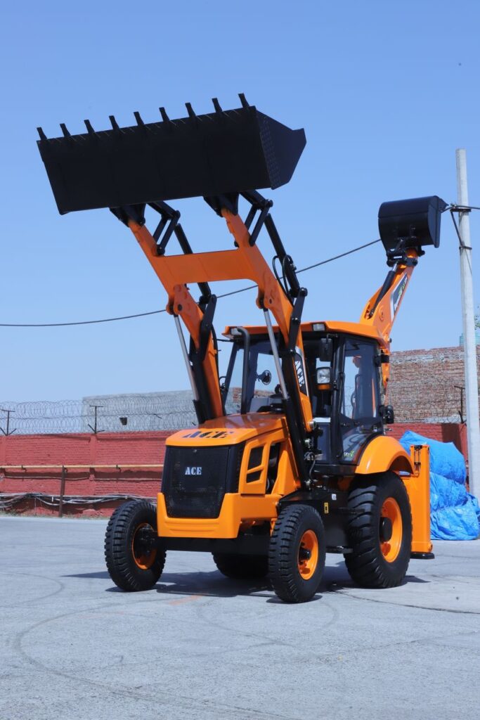 Orange ACE AX 124 backhoe loader with raised bucket under clear sky in India.